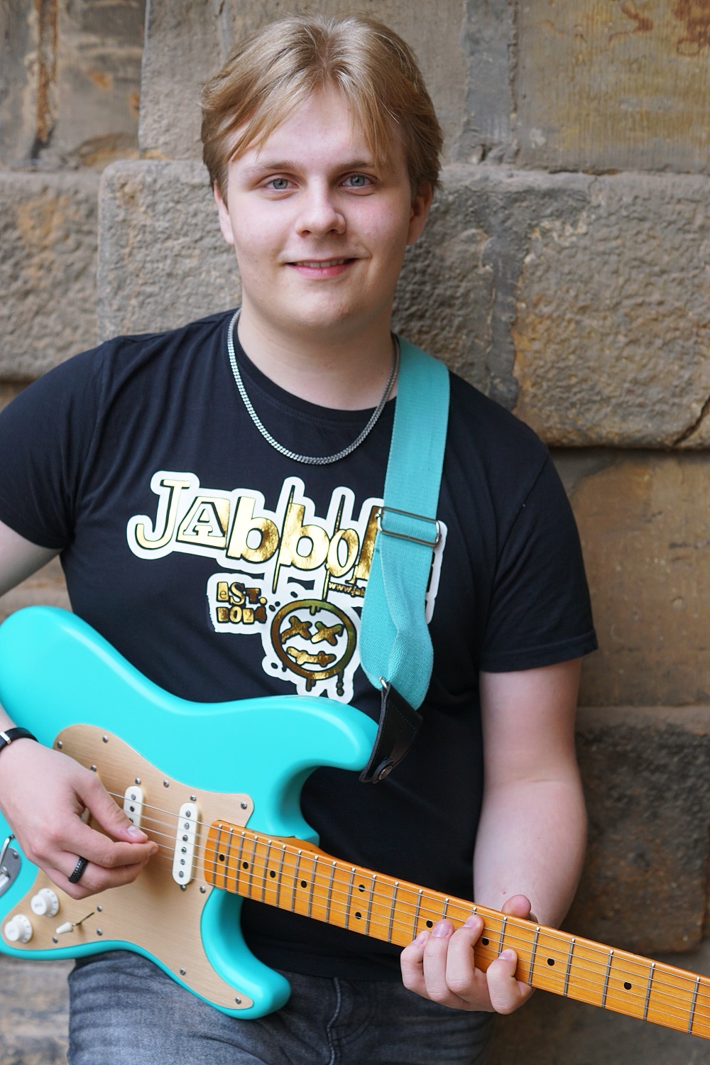 Barber 1 young man with beard smiling and wearing a  brown shirt