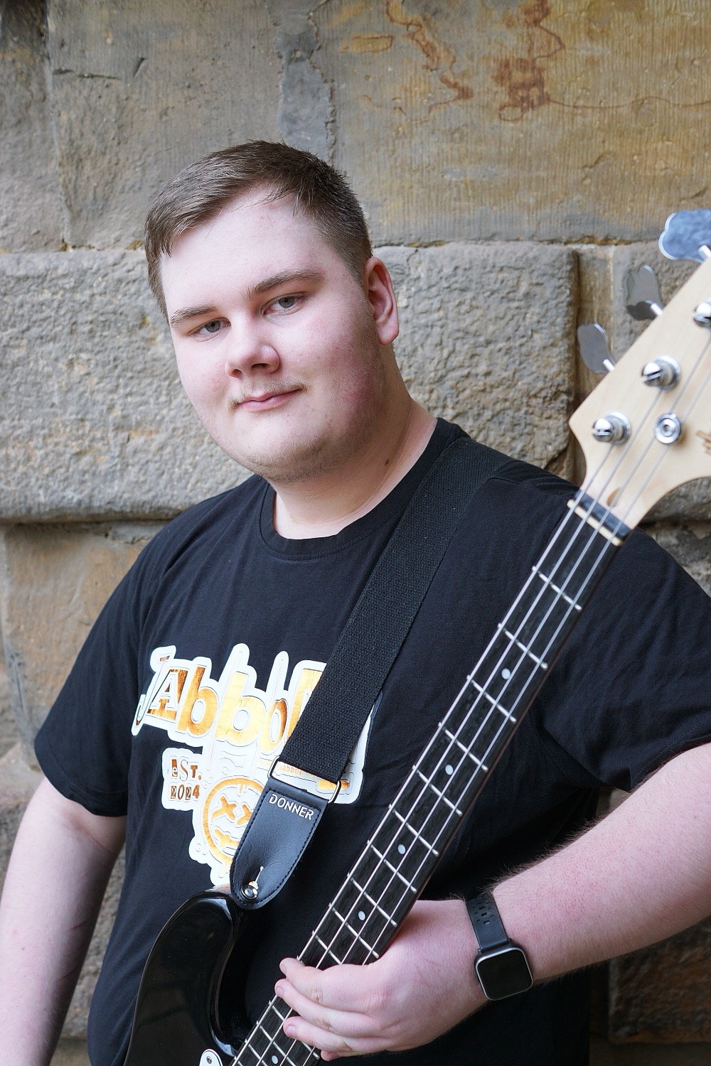 Barber 1 young man with beard smiling and wearing a  brown shirt